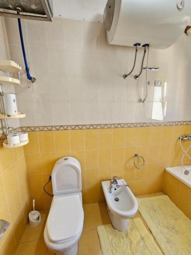 a bathroom with a toilet and a sink at EMINI Hotel in Durrës