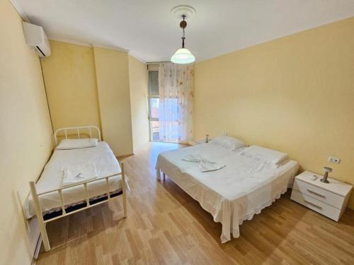 a bedroom with two beds and a window at EMINI Hotel in Durrës
