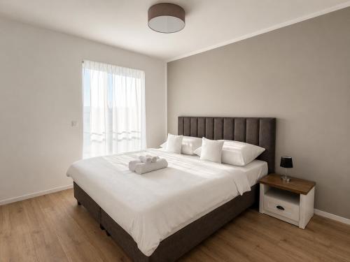 a bedroom with a large bed with a stuffed animal on it at Rivapark in Dunajská Streda