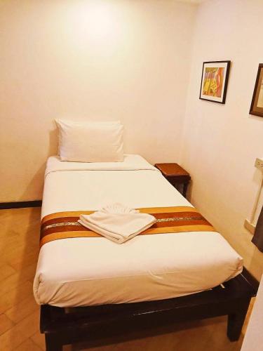 a bed in a small room with at Chedi Home in Chiang Mai