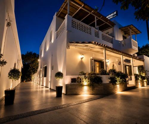 a white building with lights on a street at Semiramis Hotel in Adamantas