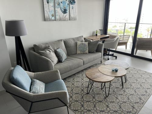 a living room with a couch and chairs and a table at Apartment-de-la-luz-calpe in Calpe