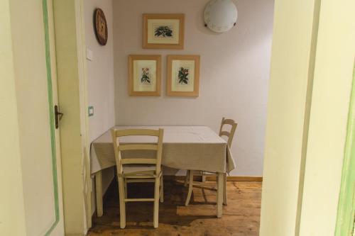 a dining room table with chairs and a clock on the wall at Cà Sagredo in Conselve