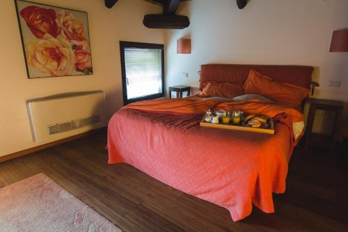 a bedroom with a bed with a tray of food on it at Cà Sagredo in Conselve