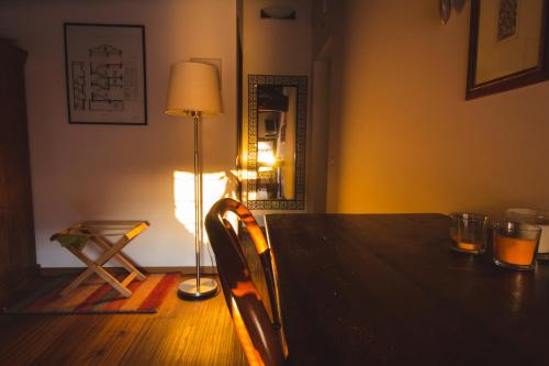 a table in a room with a lamp and a chair at Cà Sagredo in Conselve