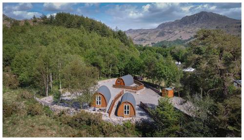 a small house sitting on top of a hill at Cosy Glamping In the Eskdale Valley - Studio Lodges and Mega Pods in Eskdale