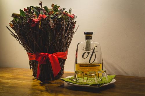 a bottle of wine next to a vase of flowers at Cà Sagredo in Conselve
