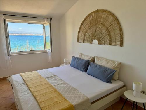 a bedroom with a bed with a view of the ocean at Casa Luma in Poljana