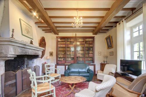 a living room filled with furniture and a fireplace at La Gaubertière in Saint-Paul-du-Bois