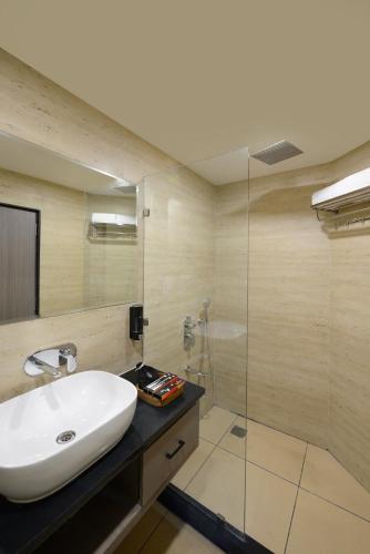 a bathroom with a sink and a glass shower at Ginger Kota, Vishwakarma Nagar in Kota