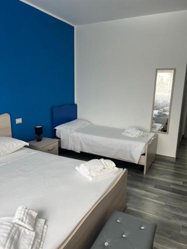 a room with two beds and a mirror at Paky' S House in Policoro