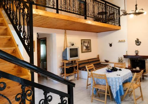a living room with a table and a balcony at Vicky's Sweet Home - Seaside Retreat in Evia in Agia Anna