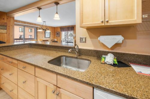 a kitchen with a sink and a counter top at Mountain House, A Vail Resorts Property in Keystone