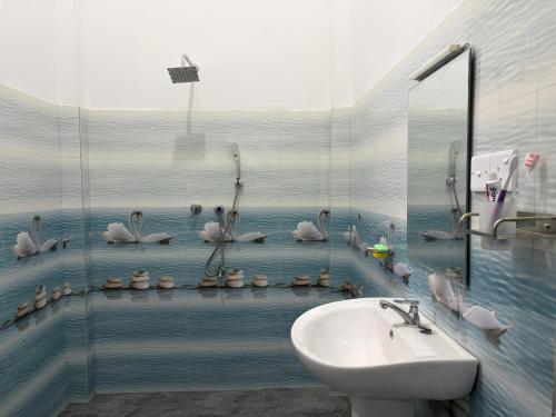 a bathroom with a sink and a flock of birds at Yala Dream Guest House in Tissamaharama