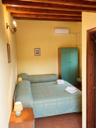 a small bedroom with a blue bed in a room at Agriturismo L'Antica Vigna in Randazzo
