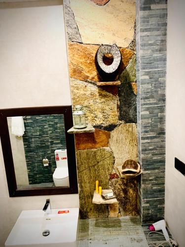 a bathroom with a sink and a mirror at Asoria Luxe Resort in Kegalle