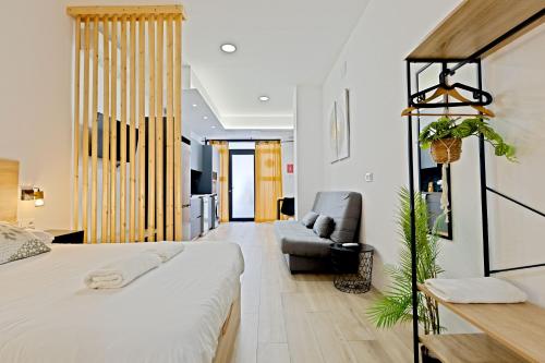 a bedroom with a large bed and a couch at Apartamento Río Turia A in Valencia