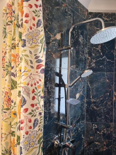 a shower in a bathroom with a shower curtain at Plage El Haouzia in El Jadida
