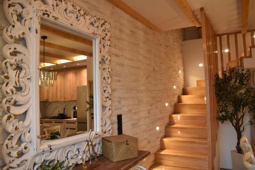a staircase in a home with a stone wall at Pelagio Residence in Samothraki