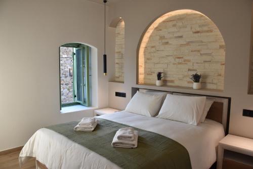a bedroom with a bed with two towels on it at Pelagio Residence in Samothraki