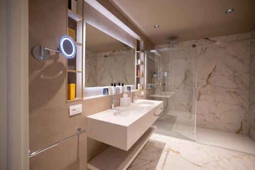 a bathroom with a sink and a shower at Tritone LUXURY HOTEL THERMAE & SPA in Abano Terme