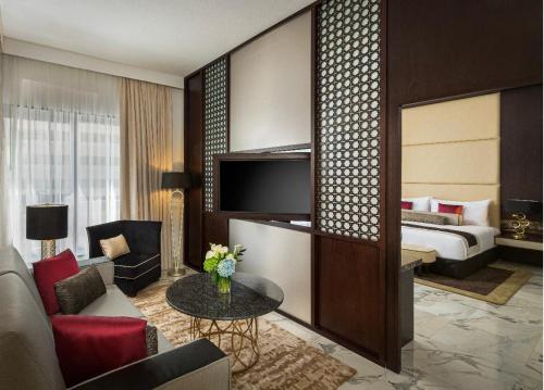 a hotel room with a bed and a living room at Hotel Vasudha Inn-Near International Airport Delhi in New Delhi