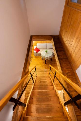 a staircase with a couch and a table in a room at Apartmány Chalupa u Floriánka in Dolní Morava