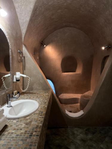 a bathroom with a sink and a mirror at Nomikos Villas in Fira