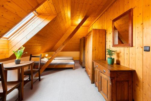 a room with a bed and a table in a cabin at Apartmány Chalupa u Floriánka in Dolní Morava