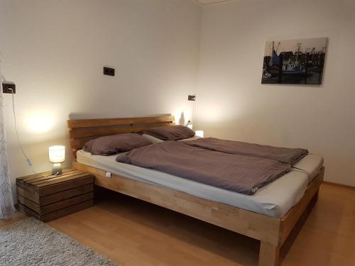 a bedroom with a large bed with two lamps on it at Wattliebe Burhave in Burhave