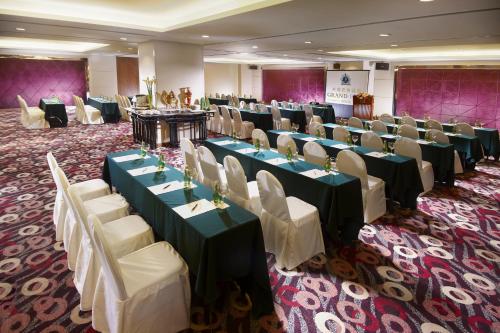 a banquet hall with tables and chairs in a room at Grand Park Wuxi in Wuxi