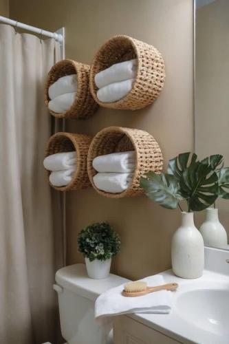 a bathroom with a toilet with baskets on the wall at Apart Hotel Ribera del Baradero - Spa y Piscina Climatizada in Baradero