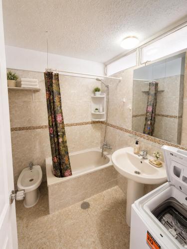 a bathroom with a sink and a tub and a toilet at 213 Borinquen Holiday in Costa de Adeje