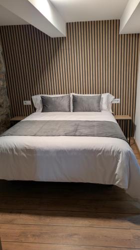 a bedroom with a large bed in a room at Casa rural Mirador, Balneario Histórico de Cortegada in Cortegada