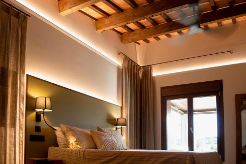 a bedroom with a bed with a large window and a window at Natura-Resort Les Pletes in Palouet