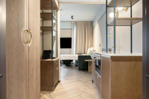 a hotel room with a bedroom with a bed at Willow, WorldHotels Crafted in Trelleborg