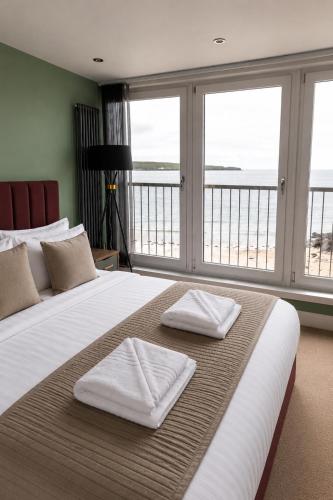 a bedroom with a large bed with two towels on it at The View from BIDE in Thurso