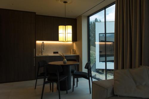 a kitchen and living room with a table and chairs at Vershky Villas Верховина in Verkhovyna