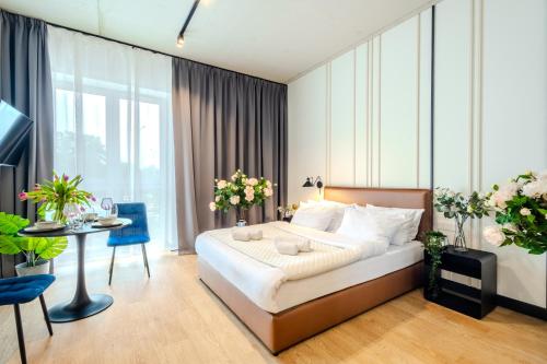 a hotel room with a bed and a table at ApartHotel S8 - Apartamenty Wrocław in Wrocław