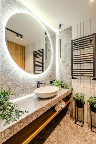 a bathroom with a sink and a mirror at ApartHotel S8 - Apartamenty Wrocław in Wrocław
