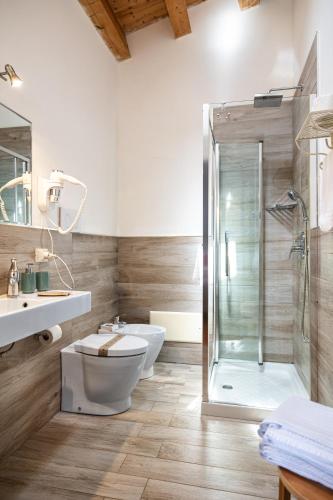 a bathroom with a shower and a toilet and a sink at Terre e Torri Country Resort in Lascari