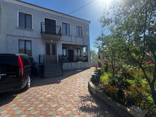 a van parked in front of a house at Terrasa Solar Kutaisi in Kutaisi