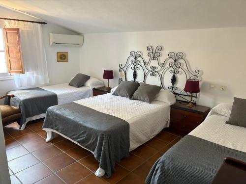 a room with three beds in a room at Cortijo Amaya in Torrox Costa