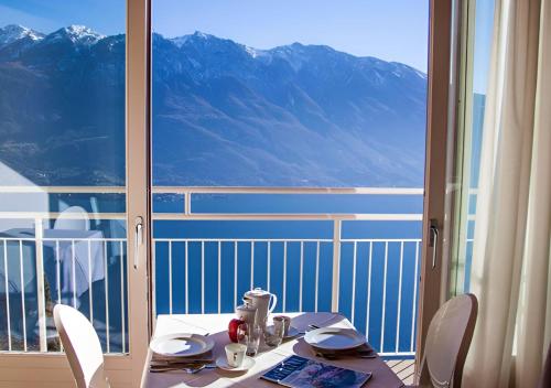 a table and chairs with a view of a mountain at Locanda Al Castelletto in Tremosine Sul Garda