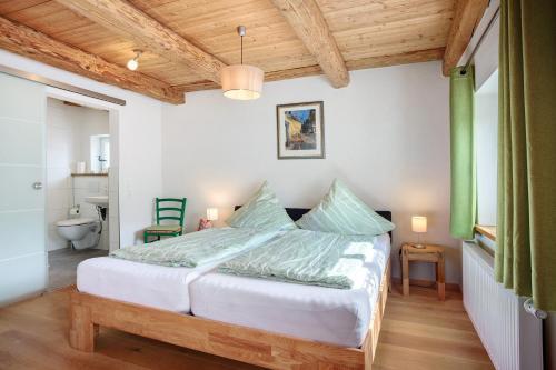 a bedroom with a bed and a bathroom at Ferienwohnung Trendelmühle Lautrach in Lautrach