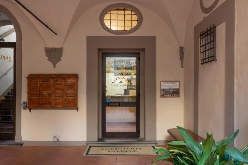 a lobby with a glass door in a building at Foresteria Valdese di Firenze in Florence