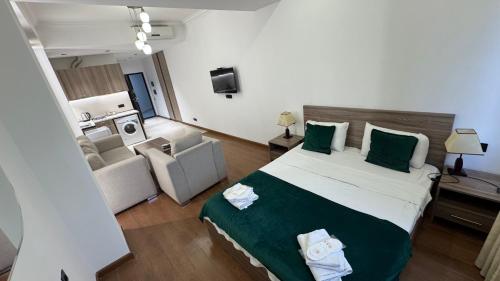 a bedroom with a large bed and a living room at M&N apartments in Yerevan