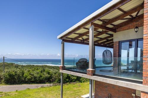 a house with a view of the ocean at Begha 180 Beach House in Begha Mouth