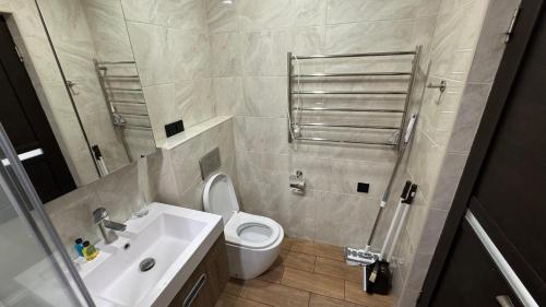 a bathroom with a toilet and a sink and a shower at M&N apartments in Yerevan