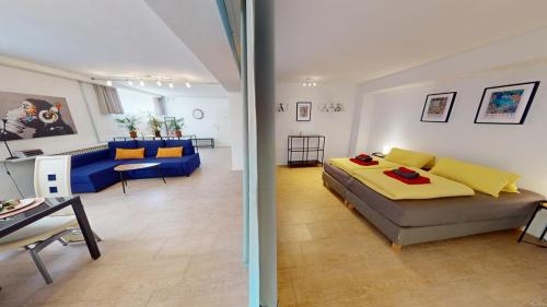 a living room with a bed and a living room with a couch at Fewo Loft Konstanz in Konstanz